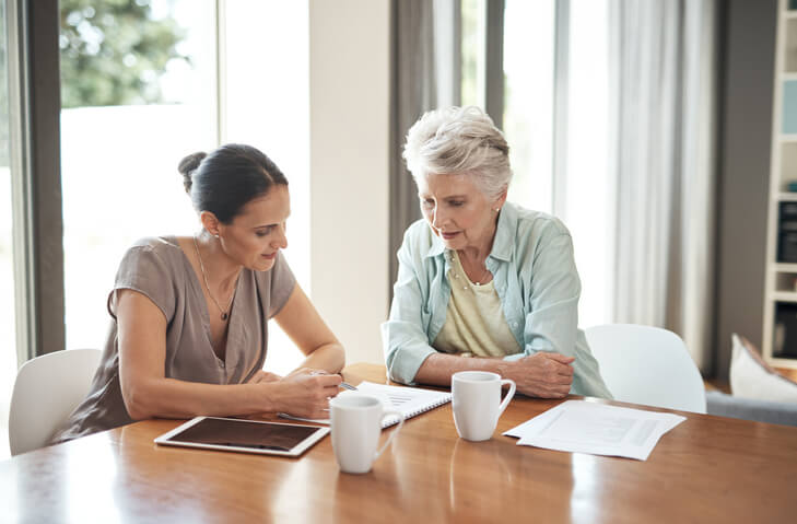 Estate planning attorney discussing trusts with older woman