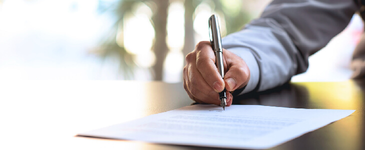Man signing business document