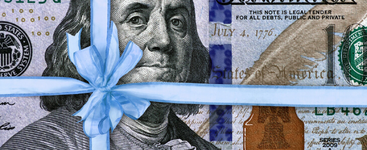 100 dollar bill wrapped with blue ribbon