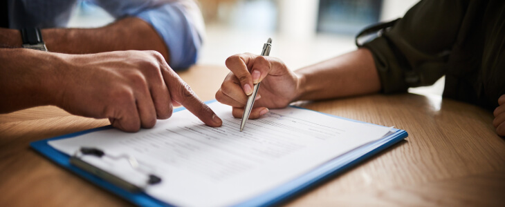 Close up of person signing a business contract