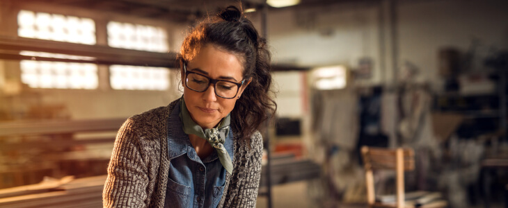 Female business owner sitting in her workshop