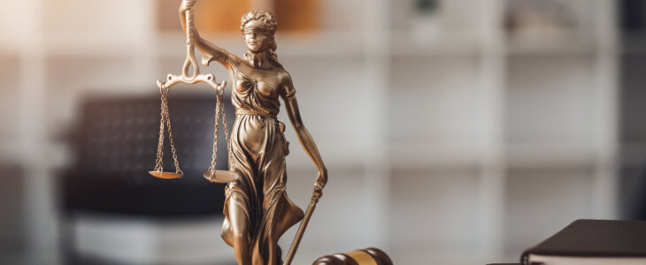 Statue of lady justice on desk of a judge or lawyer