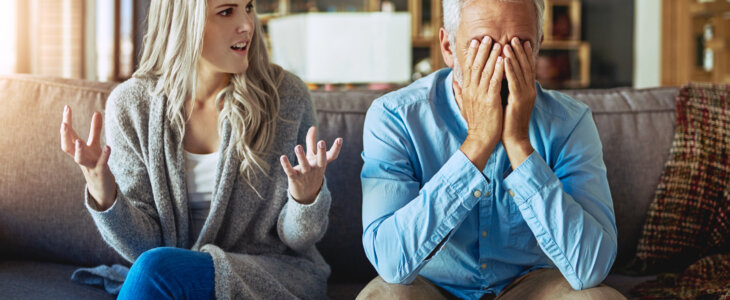 daughter angry at father sitting on couch