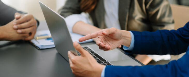 Businessman and team analyzing financial statement