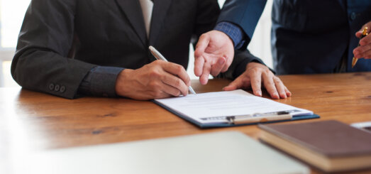 Business people signing a contract agreement.