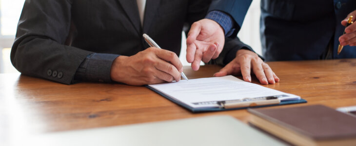 Business people signing a contract agreement.