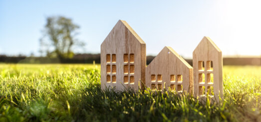 Ecological wood model house in empty field