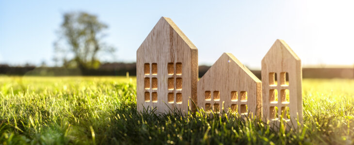 Ecological wood model house in empty field