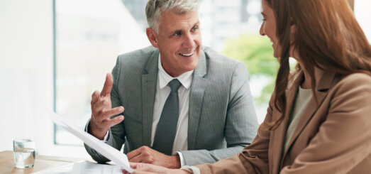 Smiling business man talking with a female colleague
