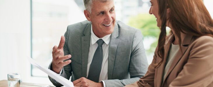 Smiling business man talking with a female colleague