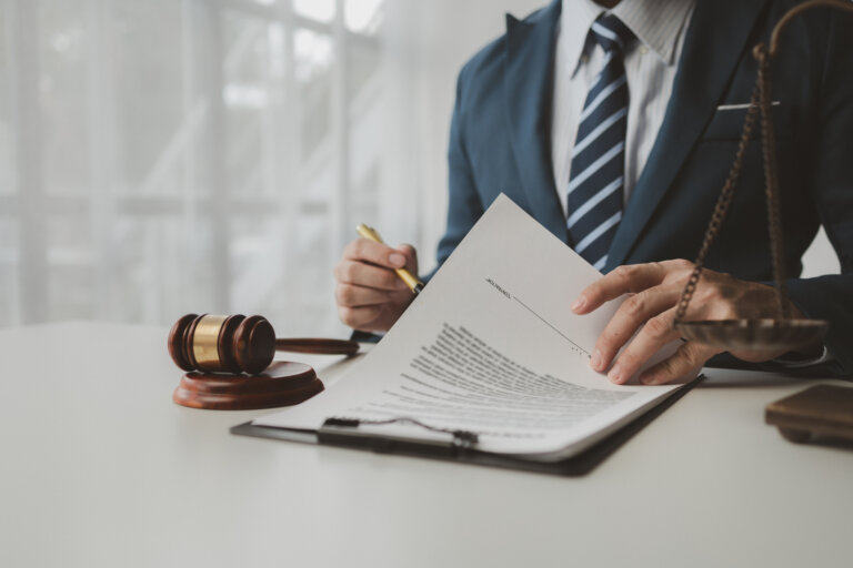 Lawyer is signing contract in the office